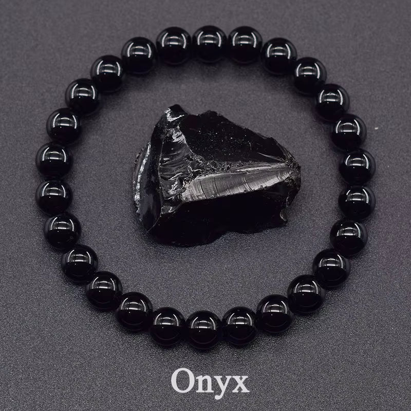 Black onyx bracelet with a raw onyx stone on a gray background