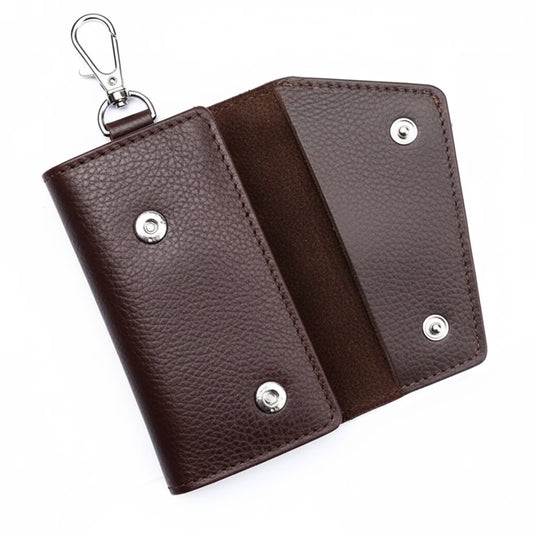 Brown leather key holder with silver accents on a white background
