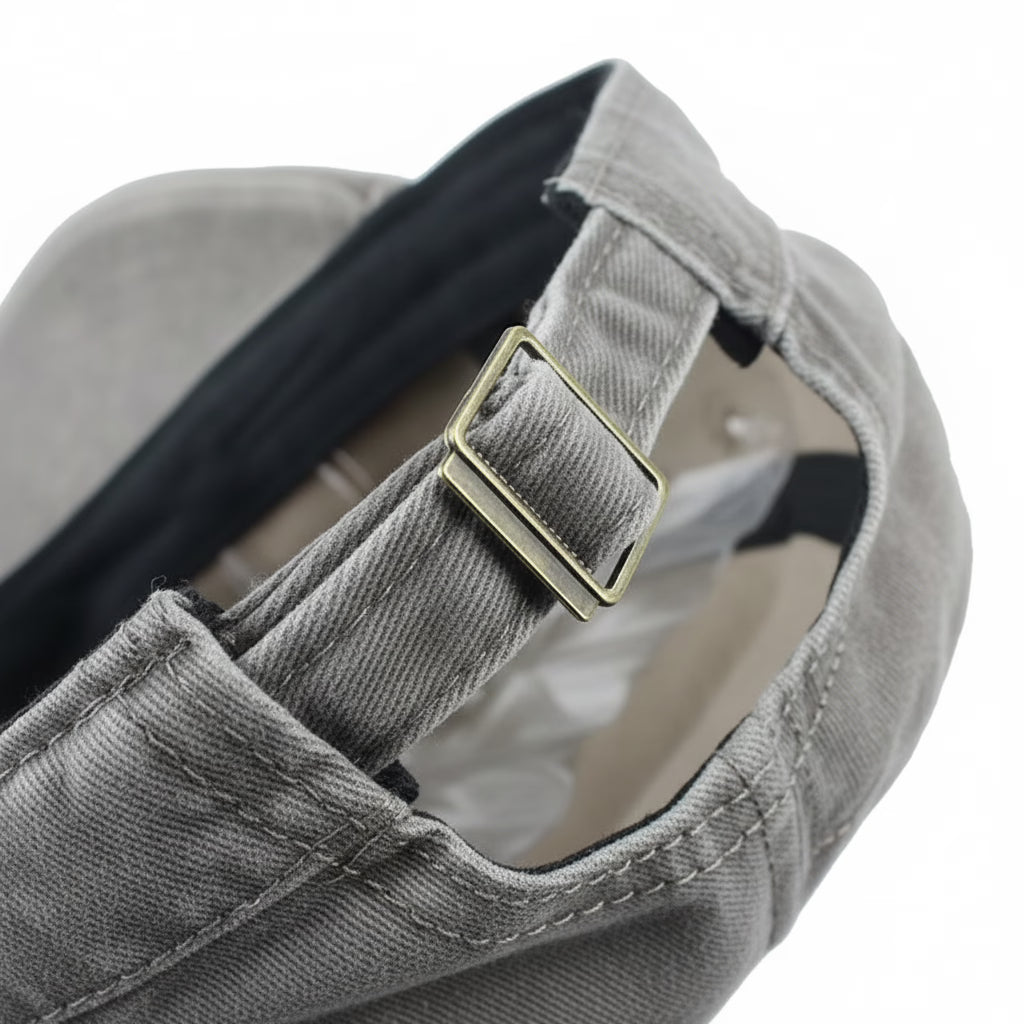 Grey military cap with a gold buckle at the back on a white background