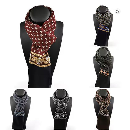 Set of patterned scarves on black mannequin stands against a white background