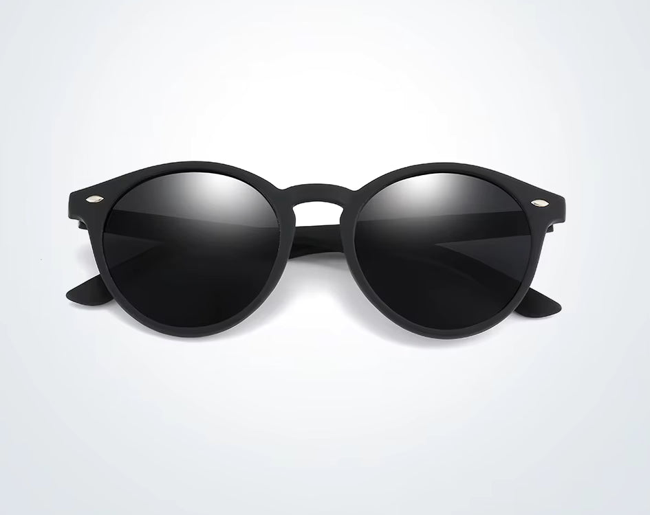 Black sunglasses with reflective lenses on a light grey background