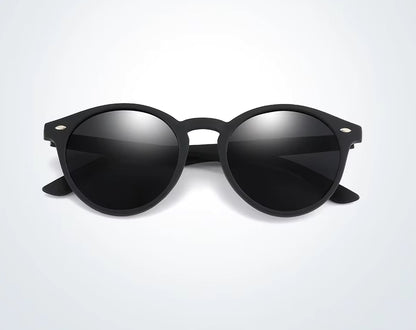 Black sunglasses with reflective lenses on a light grey background