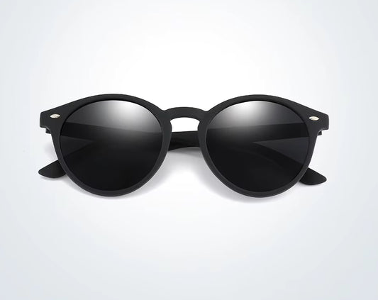 Black sunglasses with reflective lenses on a light grey background