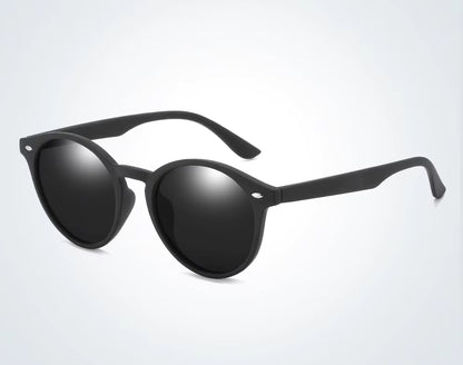 Black sunglasses with reflective lenses on a light gray background