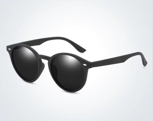 Black sunglasses with reflective lenses on a light gray background