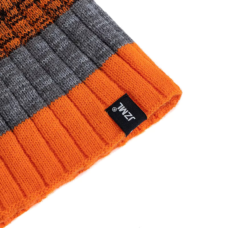 Orange and grey striped knit beanie with a brand label on a white background