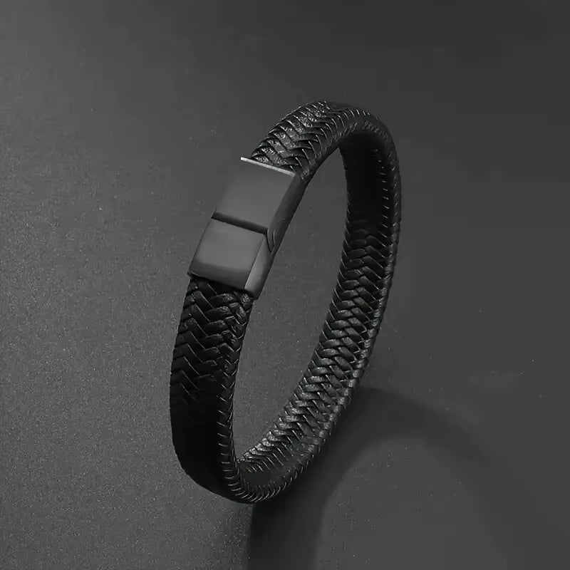 Black woven bracelet with a magnetic clasp on a dark gray background