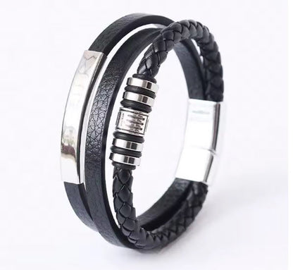 Black braided leather bracelet with silver accents on a white background