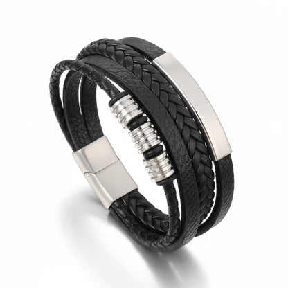 Black braided leather bracelet with silver metal accents on a white background