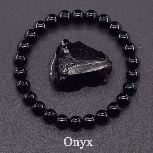 Black onyx bracelet with a raw onyx stone on a gray background