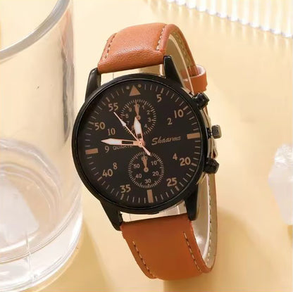 Watch with brown leather strap on a light background