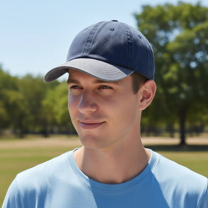 Man wearing a blue cap and light blue shirt outdoors with trees in the background