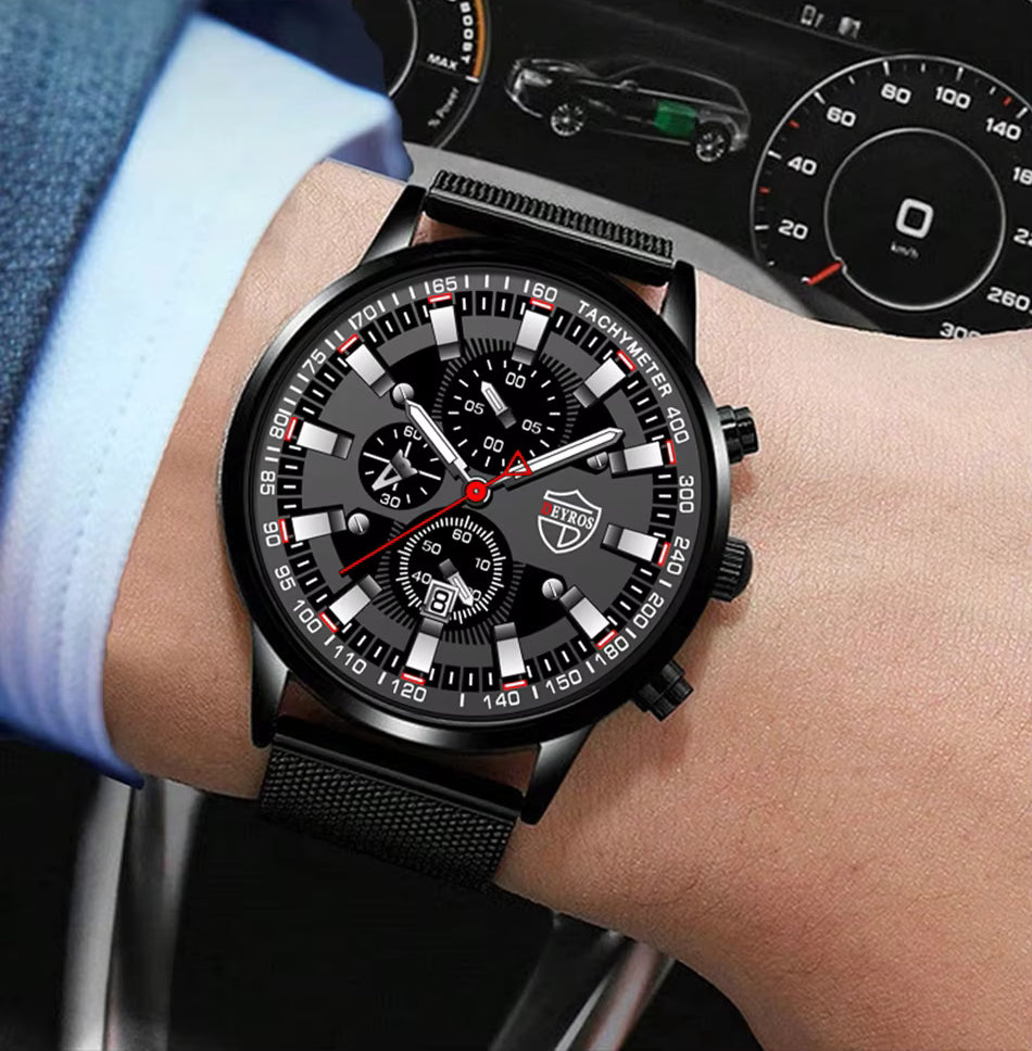Black wristwatch with detailed face on a wrist, car dashboard in the background