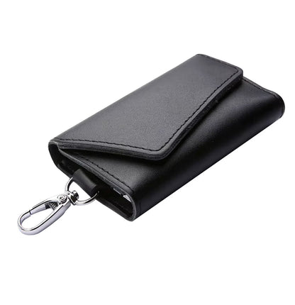 Black leather key holder with a keychain on a white background