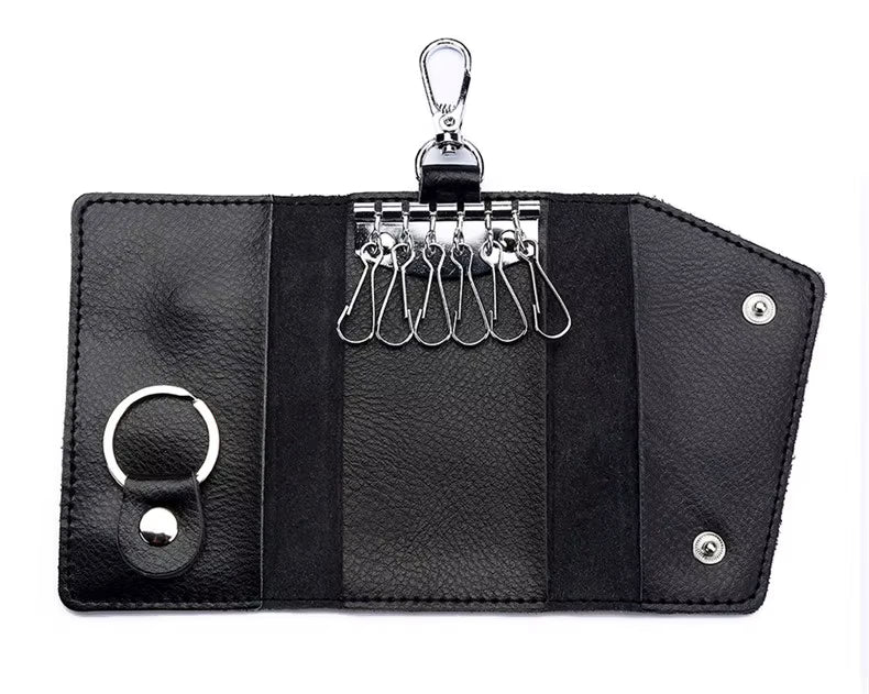 Black leather key organizer with multiple key hooks on a white background
