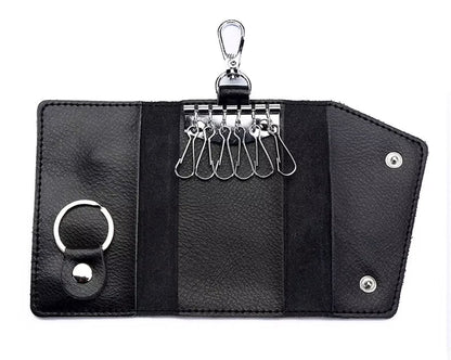 Black leather key organizer with multiple key hooks on a white background
