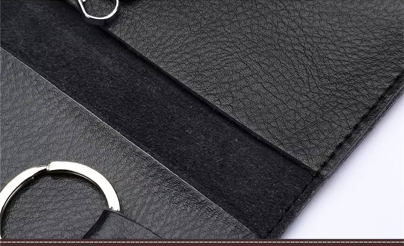 Close-up of black leather keyring with a silver ring on a white background