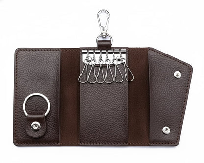 Brown leather key organizer with multiple keys on a white background