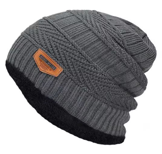 Grey knit beanie with a brown leather patch on a white background