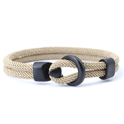 Khaki braided bracelet with black metal clasp on a white background