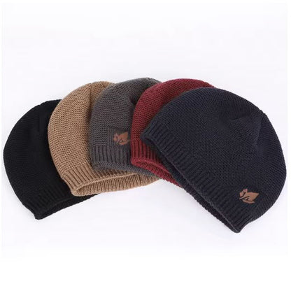 Five knit beanie hats in black, khaki, grey, burgundy , and navy on a white background.