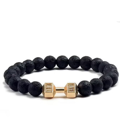 Black beaded bracelet with gold dumbbell-shaped charm on a white background