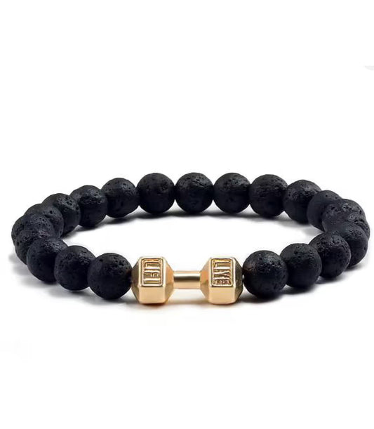 Black beaded bracelet with gold dumbbell-shaped charm on a white background
