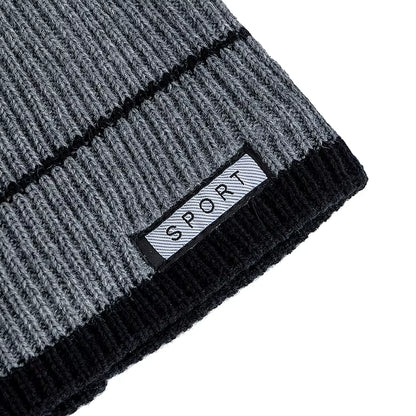 Grey and black knit beanie with a brand label on a white background