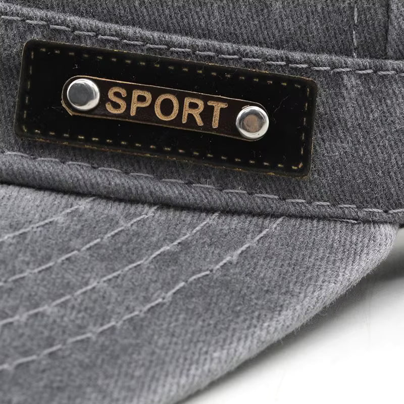 Close-up detail of Grey military cap with a 'SPORT' label on a white background