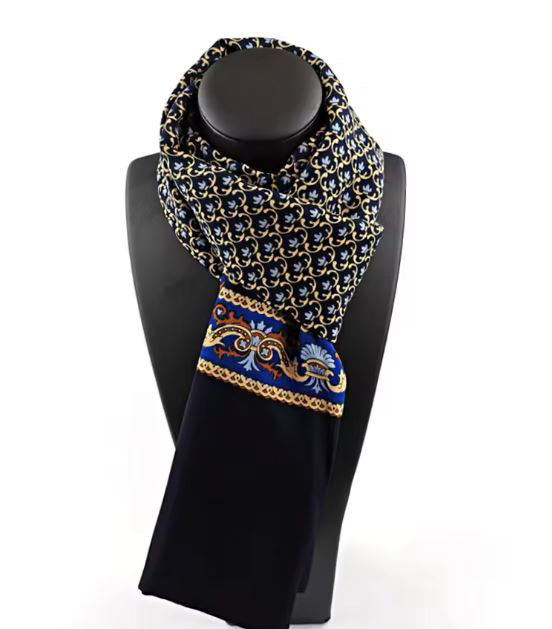 Decorative scarf with blue and gold patterns on a black mannequin against a white background