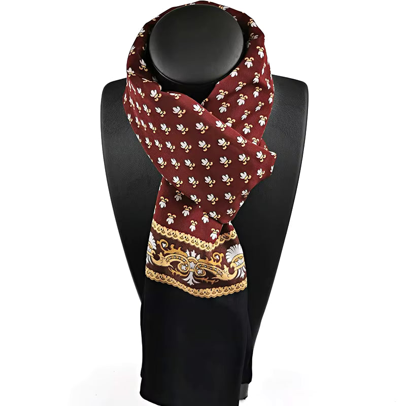 Decorative scarf with intricate patterns on a black mannequin against a white background