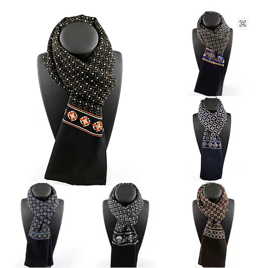 Collection of patterned scarves on black mannequin heads against a white background