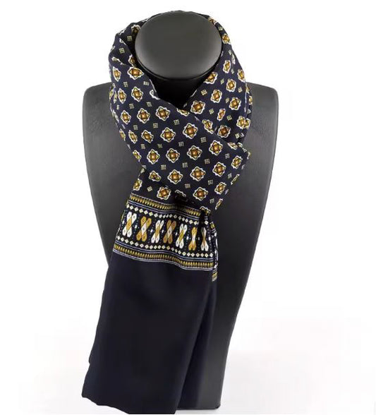 Navy blue scarf with yellow pattern on a black mannequin against a white background