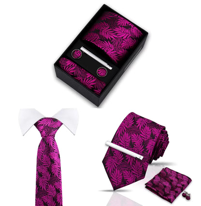 Leaf patterned tie, pocket square, tie clip and cufflinks set in a black box on a white background