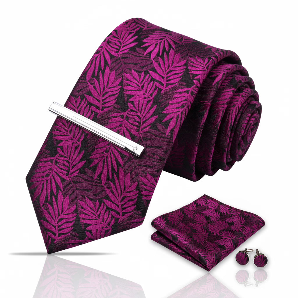 Purple leaf-patterned tie set with tie clip, pocket square, and cufflinks on a white background
