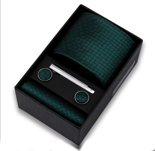 Green textured tie set with tie clip and cufflinks in a black box on a white background
