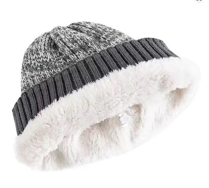 Knitted beanie with white fur lining on a white background