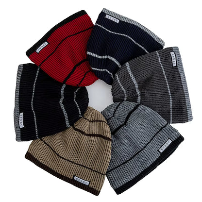 Set of knit beanies in various colors on a white background